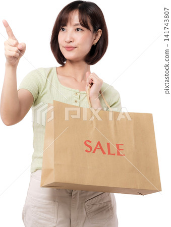 Happy young asian woman holding brown shopping bag and pointing finger up with confident expression on white studio background Happy young asian woman holding brown shopping bag and pointing finger up with confident expression on white studio background 141743807
