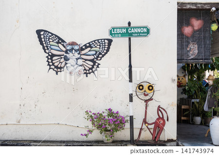 Colorful street art mural featuring a butterfly and whimsical character on a wall near a street sign, showcasing urban creativity and vibrant artistic expression in a lively setting Colorful street art mural featuring a butterfly and whimsical character on a wall near a street sign, showcasing urban creativity and vibrant artistic expression in a lively setting 141743974