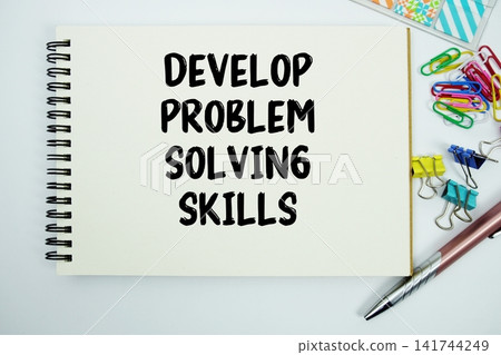 Develop Problem-solving Skills text message written on notepad with stationery flat lay on white background Develop Problem-solving Skills text message written on notepad with stationery flat lay on white background 141744249