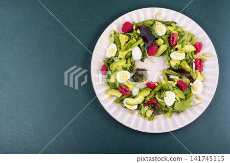 Vegetarian asparagus salad with avocado, raspberries and quail eggs Vegetarian asparagus salad with avocado, raspberries and quail eggs 141745115
