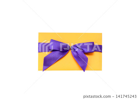 Orange greeting card or gift envelope tied with a vibrant purple satin ribbon and bow, isolated on white background, celebration and holiday concept Orange greeting card or gift envelope tied with a vibrant purple satin ribbon and bow, isolated on white background, celebration and holiday concept 141745243