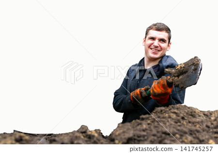 Smiling male worker wearing gloves and holding a shovel while digging soil, isolated on white background, manual labor and construction concept Smiling male worker wearing gloves and holding a shovel while digging soil, isolated on white background, manual labor and construction concept 141745257