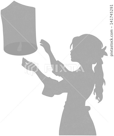 silhouette of a person releasing a sky lantern silhouette of a person releasing a sky lantern 141745291