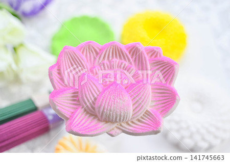 Offerings for the Obon festival: Lotus flower-shaped rakugan (a type of Japanese confectionery) and incense sticks. Offerings for the Obon festival: Lotus flower-shaped rakugan (a type of Japanese confectionery) and incense sticks. 141745663