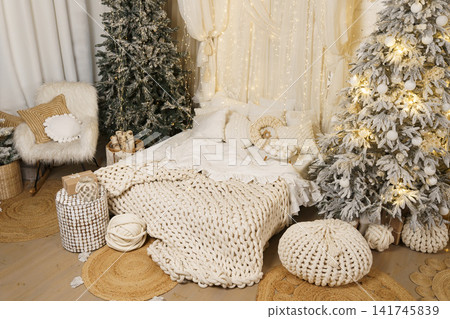 Magical Christmas Bedroom Interior with Snowy Trees and Fairy Lights Magical Christmas Bedroom Interior with Snowy Trees and Fairy Lights 141745839