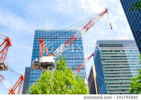 Large cranes and skyscrapers at a construction site Large cranes and skyscrapers at a construction site 141745880