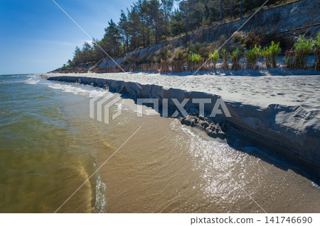 Sea waves wash away the beach Sea waves wash away the beach 141746690