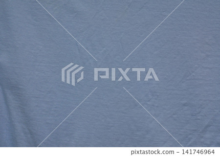 Solid blue fabric close up with fine textile texture, soft folds and small natural surface irregularities. Solid blue fabric close up with fine textile texture, soft folds and small natural surface irregularities. 141746964