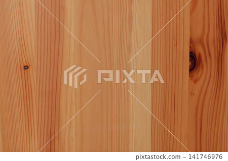 Light natural pine wood surface with even vertical grain, warm tones and several contrasting dark knots. 141746976