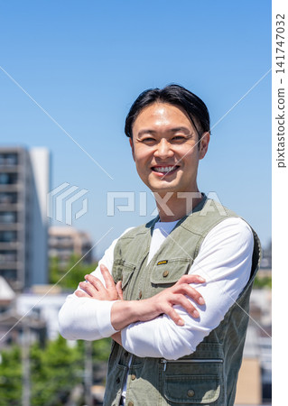 A man in the construction and real estate industry smiles and crosses his arms. A man in the construction and real estate industry smiles and crosses his arms. 141747032