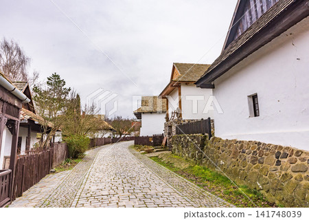 Traditional Palóc-style houses and cobblestone streets in the ancient village of Hollókő, a UNESCO World Heritage site in Hungary. Traditional Palóc-style houses and cobblestone streets in the ancient village of Hollókő, a UNESCO World Heritage site in Hungary. 141748039