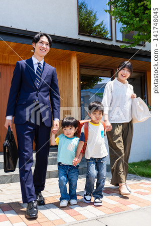 A family of four leaves home with smiles on their faces (father commuting to work and children going to daycare/school). A family of four leaves home with smiles on their faces (father commuting to work and children going to daycare/school). 141748045