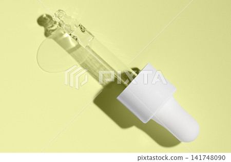 Cosmetic transparent product on a yellow background. A serum or gel or cream. Cosmetic transparent product on a yellow background. A serum or gel or cream. 141748090