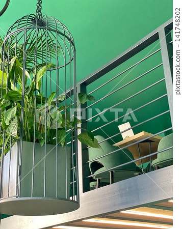 Modern interior design with green wall, minimalist furniture and indoor plants in a stylish space. Modern interior design with green wall, minimalist furniture and indoor plants in a stylish space. 141748202