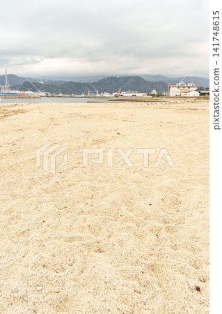 A beautiful view of Tsuruga Bay's sandy beach and the harbor towering in the distance, seen from the coast of Kehi no Matsubara. A beautiful view of Tsuruga Bay's sandy beach and the harbor towering in the distance, seen from the coast of Kehi no Matsubara. 141748615