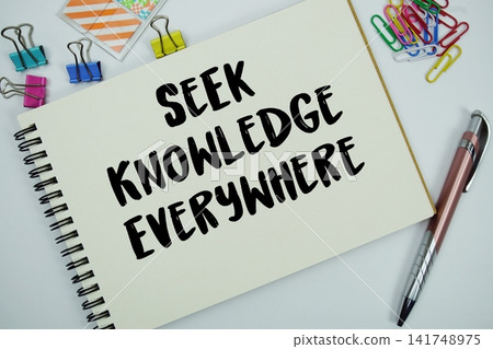 Seek Knowledge Everywhere text message written on notepad with stationery flat lay on white background Seek Knowledge Everywhere text message written on notepad with stationery flat lay on white background 141748975