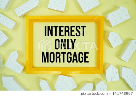 Interest-Only Mortgage text with house models on yellow background Interest-Only Mortgage text with house models on yellow background 141748997