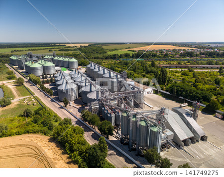 Drone shot of modern agro industrial elevator plant for grain storage Drone shot of modern agro industrial elevator plant for grain storage 141749275
