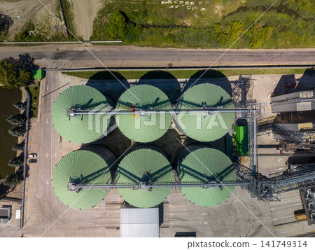 Top Down Drone View of Agroindustrial Silos with Light Green Roofs Top Down Drone View of Agroindustrial Silos with Light Green Roofs 141749314
