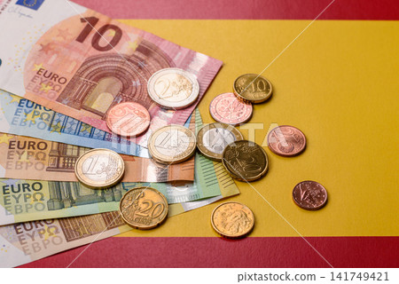 Spain, Spanish euro cash and cent coins against the background of the flag. Euro cash 141749421