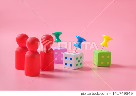 Minimal wood figures with Push pin on dice game on color background. Minimal wood figures with Push pin on dice game on color background. 141749849