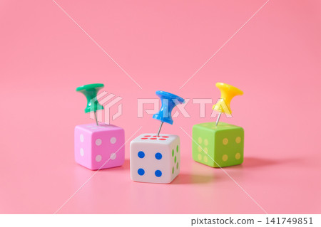 Push pin on dice game on color background. Push pin on dice game on color background. 141749851