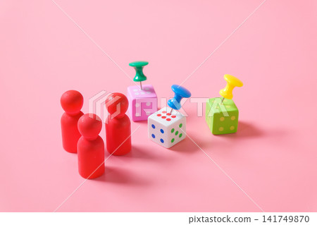 Minimal wood figures with Push pin on dice game on color background. Minimal wood figures with Push pin on dice game on color background. 141749870