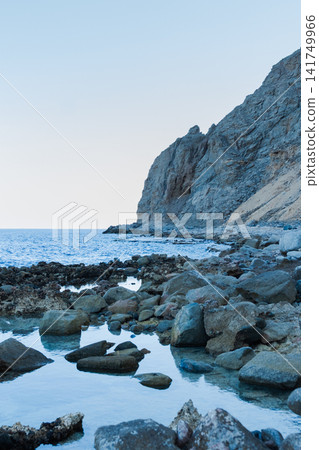 Natural pools along the Red Sea coast in Dahab, Egypt. Rocky shoreline under the Sinai mountains with clear blue water. Natural pools along the Red Sea coast in Dahab, Egypt. Rocky shoreline under the Sinai mountains with clear blue water. 141749966