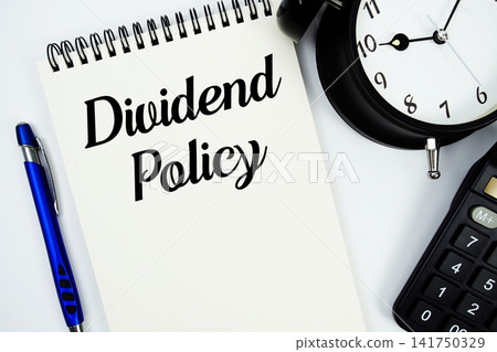 Dividend Policy text written on notepad with calculator and alarm clock Dividend Policy text written on notepad with calculator and alarm clock 141750329