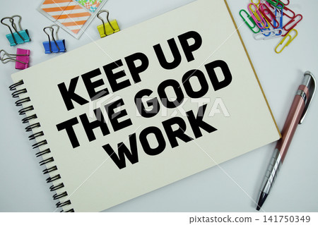 Keep Up The Good Work text message written on notepad with stationery flat lay on white background 141750349