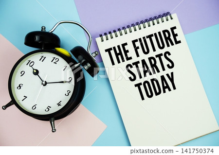The Future Starts Today text written on notepad with alarm clock flat lay on multicolor pastel background The Future Starts Today text written on notepad with alarm clock flat lay on multicolor pastel background 141750374