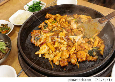 Spicy Korean Chicken Stir Fry Dakgalbi with Vegetables on Iron Pan Spicy Korean Chicken Stir Fry Dakgalbi with Vegetables on Iron Pan 141750515