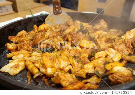 Spicy Korean Chicken Stir Fry Dakgalbi with Vegetables on Iron Pan Spicy Korean Chicken Stir Fry Dakgalbi with Vegetables on Iron Pan 141750534