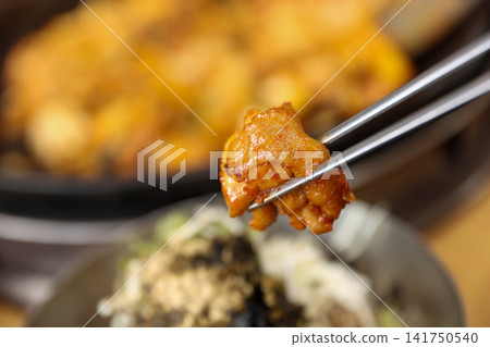 Spicy Korean Chicken Stir Fry Dakgalbi with Vegetables on Iron Pan Spicy Korean Chicken Stir Fry Dakgalbi with Vegetables on Iron Pan 141750540