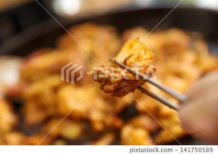 Spicy Korean Chicken Stir Fry Dakgalbi with Vegetables on Iron Pan Spicy Korean Chicken Stir Fry Dakgalbi with Vegetables on Iron Pan 141750589