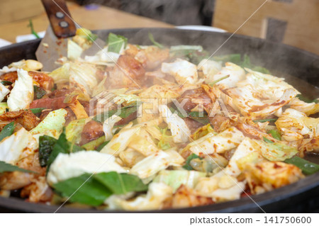 Spicy Korean Chicken Stir Fry Dakgalbi with Vegetables on Iron Pan Spicy Korean Chicken Stir Fry Dakgalbi with Vegetables on Iron Pan 141750600