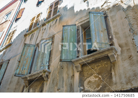 Old weathered windows with blue shutters in Rovinj, Croatia. Old weathered windows with blue shutters in Rovinj, Croatia. 141750685
