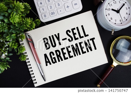 Buy-Sell Agreement text written on notepad with alarm clock, magnifying glass and calculator on black background Buy-Sell Agreement text written on notepad with alarm clock, magnifying glass and calculator on black background 141750747