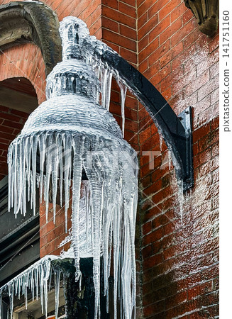 Street Lantern Covered in Thick Icicles and Ice After Freezing Rain Storm Street Lantern Covered in Thick Icicles and Ice After Freezing Rain Storm 141751160