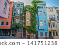 Istanbul, turkey, august 2, 2025 vibrant facades of traditional buildings in balat, a historic fener neighborhood, showcasing unique urban architecture and climbing ivy 141751238