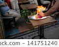 Istanbul, turkey, august 2, 2025 chef preparing traditional testi kebab dish with fire at an outdoor restaurant in istanbul, turkey, offering authentic culinary experience 141751240