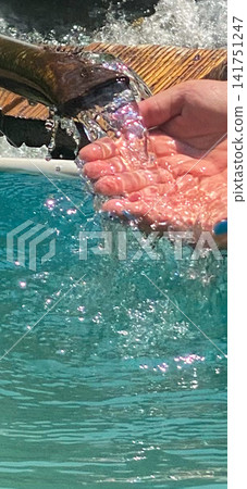 Hands Under Flowing Pool Water Hands Under Flowing Pool Water 141751247