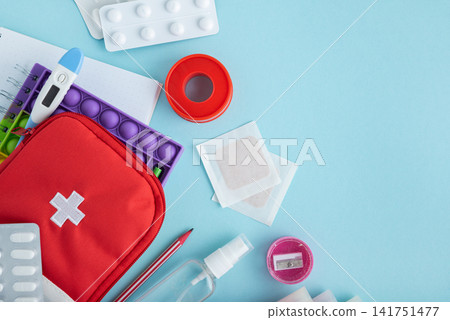 Medical supplies and first aid kit components arranged on a pastel blue background Medical supplies and first aid kit components arranged on a pastel blue background 141751477