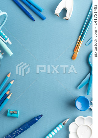Blue stationery arranged on a blue background Blue stationery arranged on a blue background 141751482