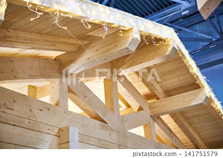 Frame of wooden house with festive garland Frame of wooden house with festive garland 141751579