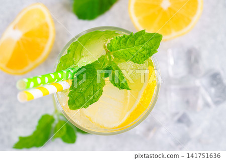 Top view of refreshing homemade lemonade. Fresh mint, lemon slices, ice in glass, cold beverage Top view of refreshing homemade lemonade. Fresh mint, lemon slices, ice in glass, cold beverage 141751636