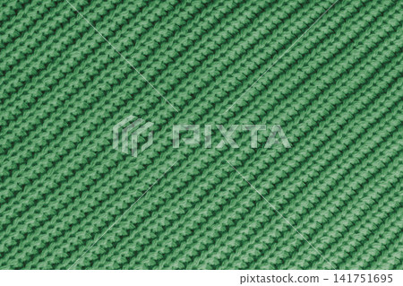 Close up, macro green knitted fabric texture with diagonal yarn stitches, cloth wool background 141751695