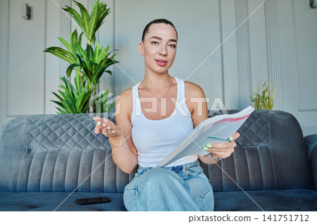 Smiling young woman looking at webcam during online video call Smiling young woman looking at webcam during online video call 141751712