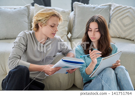 Young students studying together, looking at each other, confused. Young students studying together, looking at each other, confused. 141751764