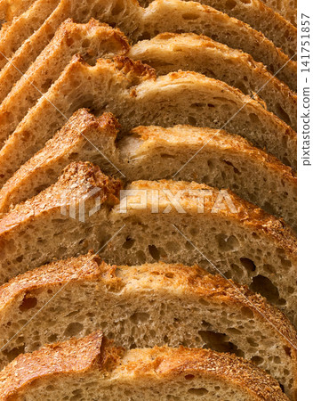close up crusty loaf of sourdough bread , food texture. close up wheat bread with sourdough , food textured. wheat bread close up. close up crusty loaf of sourdough bread , food texture. close up wheat bread with sourdough , food textured. wheat bread close up. 141751857